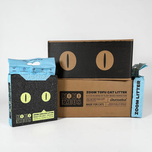 Two Koko Zeus ZOOM Tofu Cat Litter bags with a two cardboard boxes on a white background